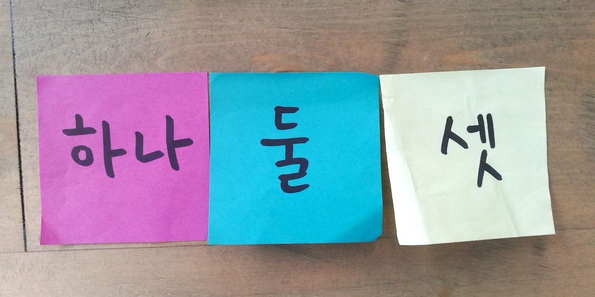 Three sticky notes with the words 'one,' 'two,' and 'three' respectively.